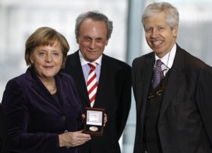 German Chancellor Merkel poses with a medal for the media after she was awarded by Prince Nikolaus of Liechtenstein, vice president of the European Coudenhove-Kalergi association Hoechtl of Austrian People's Party at the Chancellery in Berlin
